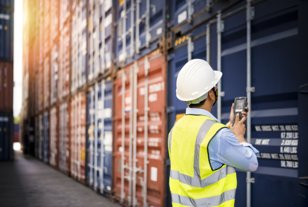 A man checking on Containers in a port terminal - Ecosistema Milos